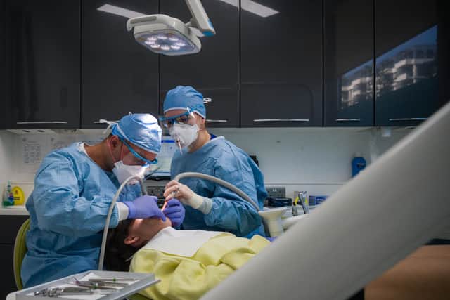 A dentist and dental nurse carry out a procedure on a patient (Photo by Leon Neal/Getty Images)