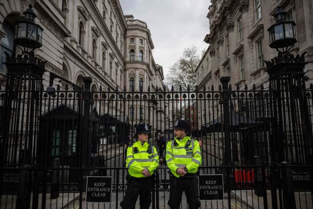 Two police officers are seen standing outside the gates to Downing Street on April 12, 2022 in London, England (Photo by Rob Pinney/Getty Images)