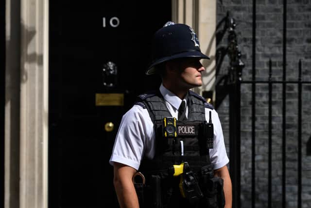 A police officer walks past the front door of number 10, Downing Street (Photo by Leon Neal/Getty Images)