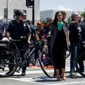 US Representative Alexandria Ocasio-Cortez is detained after participating in a sit in with activists from Center for Popular Democracy (Pic: Getty Images)