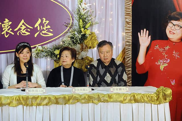 Joyce Cheng (L), daughter of TV star Lydia Shum (poster at R) speaks at a press conference accompanied by friends and relatives in Hong Kong February 20, 2008 (Photo by MIKE CLARKE/AFP via Getty Images)