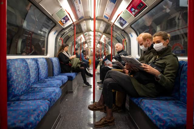A couple sit on the Central Line Tube in London, England (Pic: Getty Images)