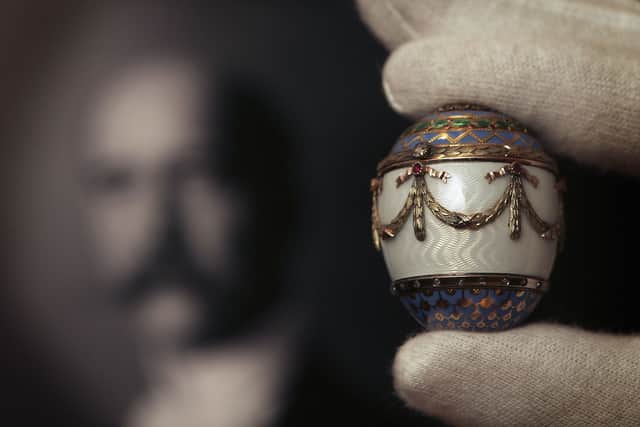 A Christie’s employee holds up a Faberge enamel and two colour gold egg  (Pic: Getty Images)