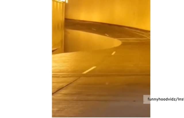 Baffling optical illusion makes it look like a pit has opened in the road