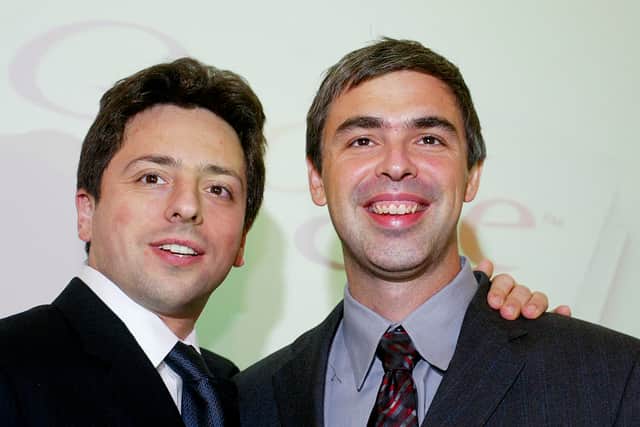 Google founders Sergey Brin (L) and Larry Page (R) smile prior to a news conference during the opening of the Frankfurt bookfair on October 7, 2004 in Frankfurt, Germany (Photo by Ralph Orlowski/Getty Images)