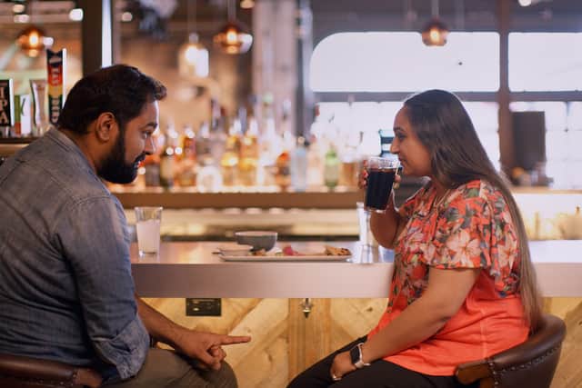 Vyasar Ganesan and Rashi Gupta, sat together at a bar (Credit: Netflix)