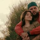 Teresa Ruiz as Maria and Mo Amer as Mo, his arms wrapped around her (Credit: Netflix)