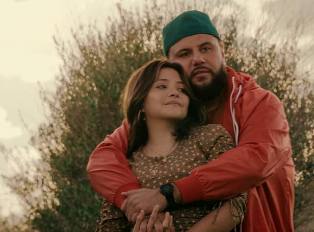 <p>Teresa Ruiz as Maria and Mo Amer as Mo, his arms wrapped around her (Credit: Netflix)</p>
