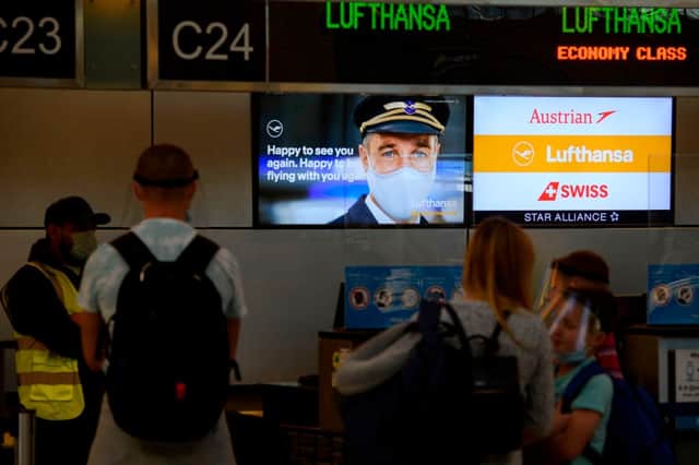 Travellers check-in for Lufthansa flights at the Tom Bradley International Terminal (TBIT) amidst travel restrictions during the Covid-19 pandemic (Photo by PATRICK T. FALLON/AFP via Getty Images)