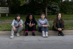 Riley Lai Nelet as Erin Tieng, Camryn Jones as Tiffany Quilkin, Fina Strazza as KJ Brandman, and Sofia Rosinsky as Mac Coyle, sat on the roadside (Credit: Anjali Pinto/Prime Video)