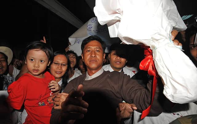 Myanmar political prisoner Kyaw Min Yu (C), known as Jimmy, and his wife Ni Lar Thein (L) holding her child, both members of the 88 Generation student group (Photo by Soe Than WIN/AFP via Getty Images)