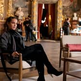 Alicia Vikander as Mira in Irma Vep, sat in an ornate French room (Credit: HBO)