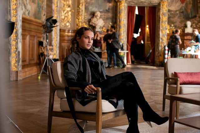 Alicia Vikander as Mira in Irma Vep, sat in an ornate French room (Credit: HBO)
