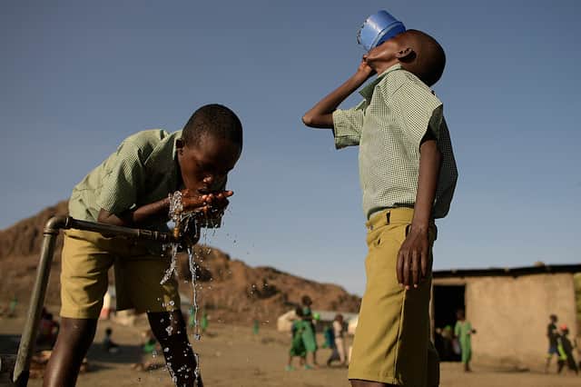 <p>Pupils of El-molo bay primary school drink from a tap, in Loiyangalani, northern Kenya, on July 13, 2022. At least 18 million people across the Horn of Africa are facing severe hunger as the worst drought in 40 years devastates the region (Getty Images)</p>