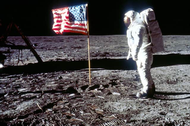Buzz Aldrin pictured next to the US flag the Apollo 11 mission planted on the moon (image: Getty Images)