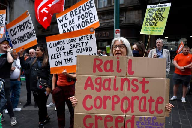 Rail workers and supporters stand on a picket line outside Glasgow Central station as a nationwide strike called by the RMT Union was held today on July 27, 2022  (Photo by Jeff J Mitchell/Getty Images)