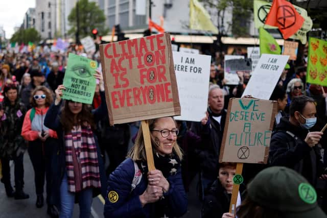 Activists march along Oxford Street during a demonstration  by the climate change protest group Extinction Rebellion in London on April 9, 2022 (Photo by TOLGA AKMEN/AFP via Getty Images)