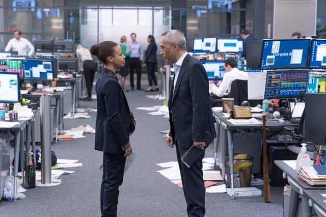 Myha’la Herrold as Harper Stern and Ken Leung as Eric Tao, confronting one another in a busy office (Credit: Simon Ridgeway/BBC/Bad Wolf/HBO)