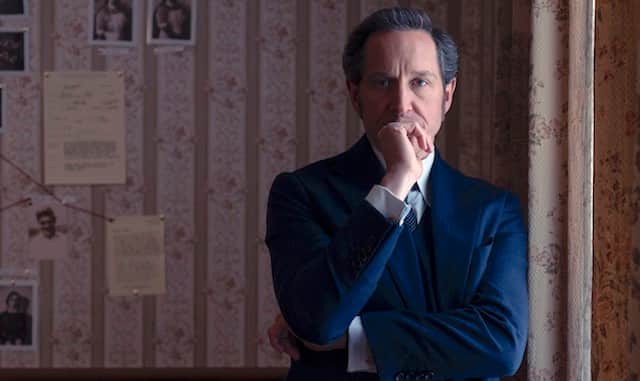 Bertie Carvel as Adam Dalgliesh, one hand resting on his chin (Credit: Christopher Barr/AcornTV/Channel 5)