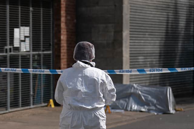 A forensic officer near the scene in Boston after a nine-year-old girl died from a suspected stab wound. Picture date: Friday July 29, 2022.