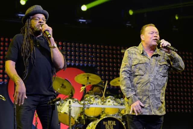 Musicians Astro (L) and Ali Campbell of UB40 perform on stage