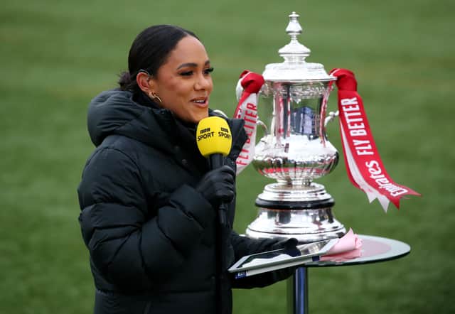  BBC Sport presenter Alex Scott stands next to the FA Cup Trophy on the pitch in 2021 (Pic: Getty Images)
