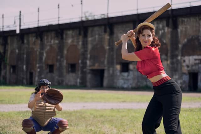 Abbi Jacobson as Carson, the catcher, and D’Arcy Carden as Greta, holding the baseball bat (Credit: Anne Marie Fox/Prime Video)