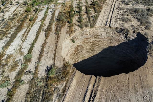 Aerial view taken on August 1, 2022, showing a large sinkhole that appeared over the weekend near the mining town of Tierra Amarilla, Copiapo Province, in the Atacama Desert in Chile. (Pic:  AFP via Getty Images)