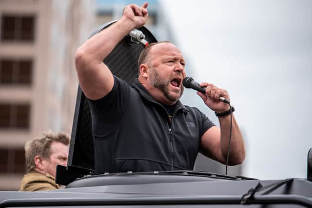 Infowars host Alex Jones protests outside the Texas State Capital building on April 18, 2020 in Austin, Texas, to call for the country to be opened up despite the risk of the COVID-19. (Photo by Sergio Flores/Getty Images)