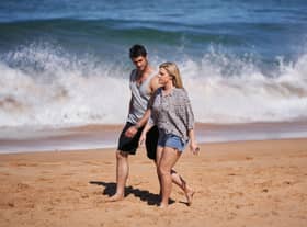 Home and Away characters Ziggy and Tane walking on the beach at Summer Bay (Pic: Endemol Shine/PA Media)
