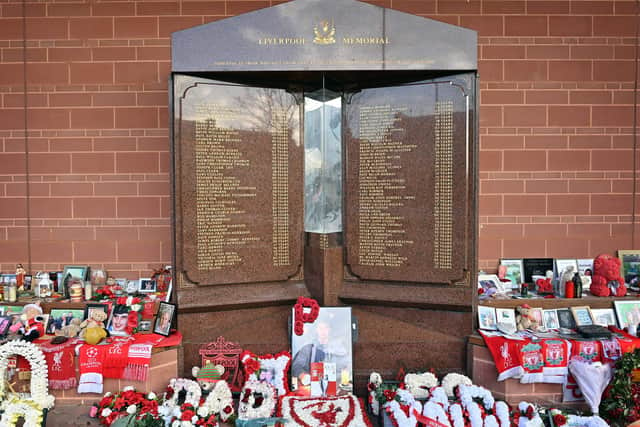 Flowers, shirts and photographs surround the eternal flame of the Hillsborough memorial at Anfield in Liverpool (Pic: AFP via Getty Images)