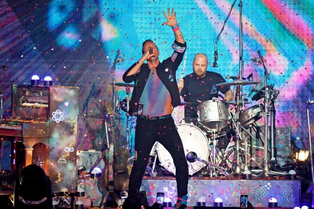 Chris Martin and Will Champion of Coldplay perform onstage in January 2022 (Photo: Frazer Harrison/Getty Images)