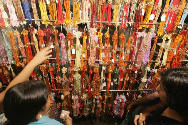 Indian women purchase 'rakhis' (traditional wrist-bands) on the eve of the Hindu festival of Raksha Bandhan