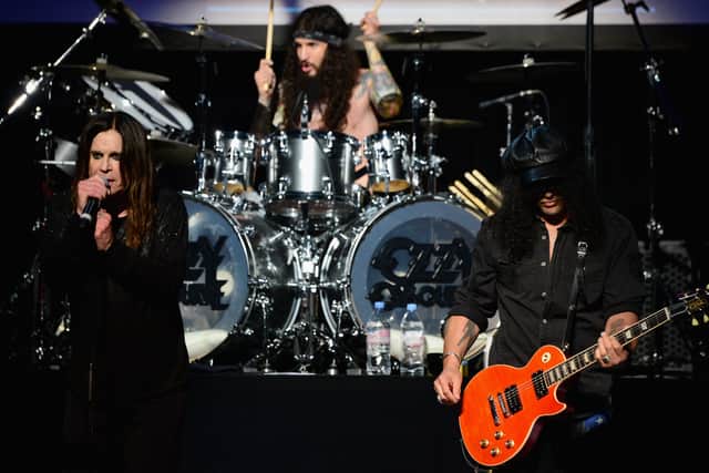 Ozzy Osbourne performing on stage with Slash