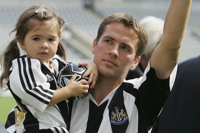 Newcastle United's new signing Michael Owen carries his daughter, Gemma, as he is introduced to the fans at St James' Park on August 31, 2005