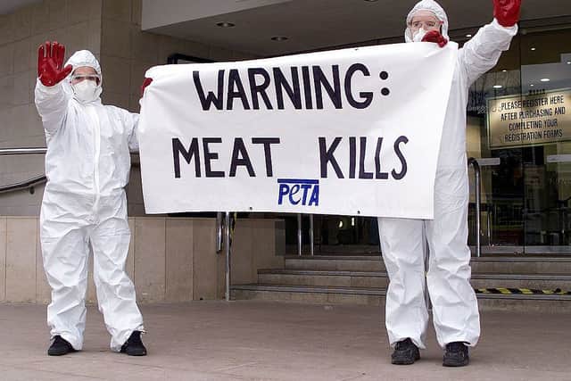 Protesters from PETA try to stop the public from entering the Smithfield 2000 agriculture exhibition at Earls Court in London 27 November 2000 (Photo by GERRY PENNY/AFP via Getty Images)