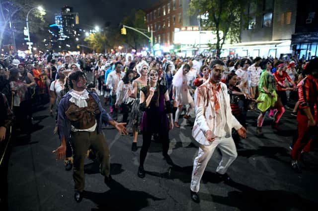 People in zombie costumes participate in the annual Village Halloween parade on Sixth Avenue on October 31, 2019 in New York. (Photo by JOHANNES EISELE/AFP via Getty Images)