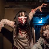 An actress and an actor dressed as zombies perform as customers dine in The Lock Up Tokyo prison themed restaurant in Tokyo, Japan (Photo by Tomohiro Ohsumi/Getty Images)