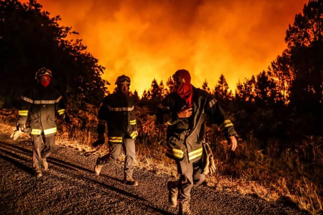 Firefighters work at the site of a wildfire near Belin-Beliet, southwestern France overnight on August 11, 2022 (Photo by THIBAUD MORITZ/AFP via Getty Images)