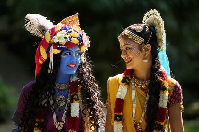 Laxmipriya Patel (L), aged 20, dressed as the Hindu god Lord Krishna, and her sister Mohini Patel, aged 13, dressed as Lord Krishna's devotee Radharani