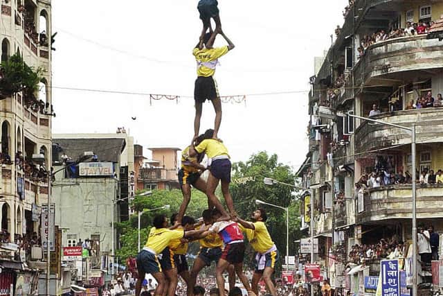 A human pyramid makes a successful attempt at breaking a pot of curd