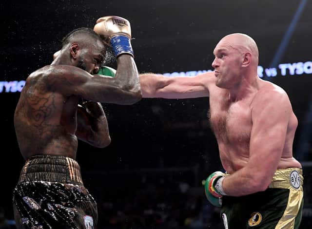 Tyson Fury punches Deontay Wilde in the seventh round fighting to a draw during the WBC Heavyweight Championship at Staples Center on December 1, 2018 
