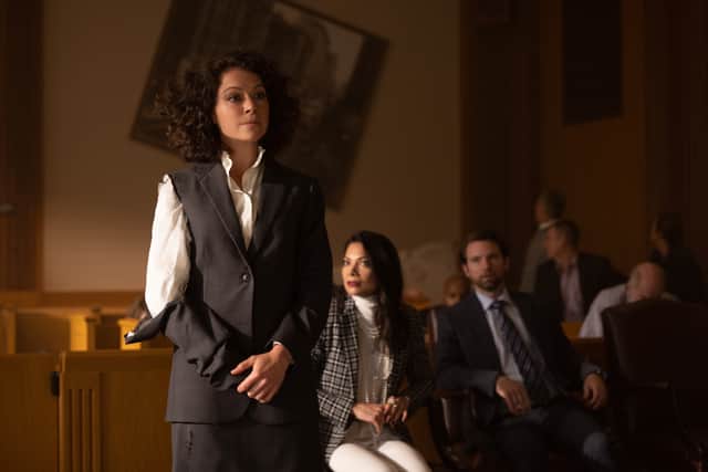 Tatiana Maslany as Jennifer Walters, Ginger Gonzaga as Nikki Ramos, and Drew Matthews as Dennis Bukowski in She-Hulk: Attorney at Law.  Jen is presenting to the court, with the others in the galleys behind her; she’s disheveled, with her sleeve ripped and hair out of place, having just transformed into She-Hulk (Credit: Chuck Zlotnick/Marvel Studios)