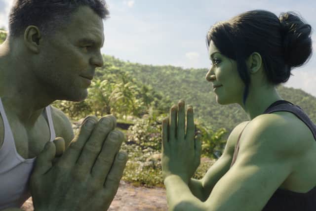 Mark Ruffalo as the Hulk and Tatiana Maslany as She-Hulk. They’re both big and green, with their hands together as though praying, staring into one another’s eyes and concentrating (Credit: Marvel Studios)