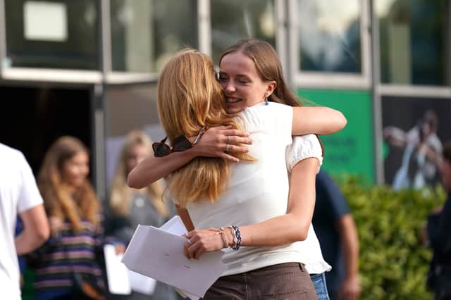 Abi Hill hugging a person after reading their A-level results at Norwich School, Norwich. Credit: PA