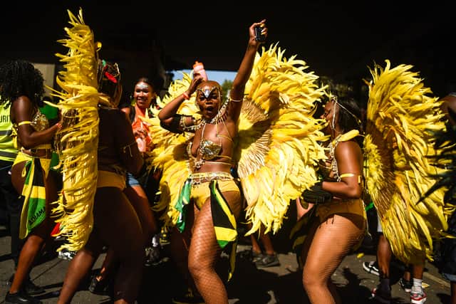 LONDON, ENGLAND - AUGUST 26: Revellers and paraders during the Notting Hill carnival on August 26, 2019 in London, England. One million people are expected on the streets in scorching temperatures for the Notting Hill Carnival. The Metropolitan Police have a large security operation in place, including “significantly more” knife arches than last year, to deliver what they hope will be a “safe and spectacular” festival. (Photo by Peter Summers/Getty Images)