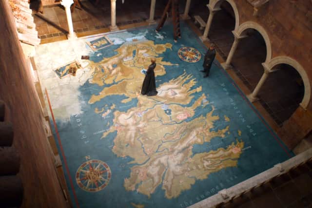 Cersei Lannister walks over a map of Westeros in Game of Thrones