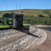 MERTHYR TYDFIL, WALES - AUGUST 12: The outlet tower stands atop the dried shore of the Beacons Reservoir as it lies low during the current heat wave, on August 12, 2022 in Merthyr Tydfil, Wales. Areas of the UK were declared to be in drought today as the country's Met Office continues its amber extreme heat warning for parts of England and Wales. (Photo by Carl Court/Getty Images)