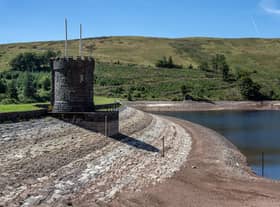 MERTHYR TYDFIL, WALES - AUGUST 12: The outlet tower stands atop the dried shore of the Beacons Reservoir as it lies low during the current heat wave, on August 12, 2022 in Merthyr Tydfil, Wales. Areas of the UK were declared to be in drought today as the country's Met Office continues its amber extreme heat warning for parts of England and Wales. (Photo by Carl Court/Getty Images)