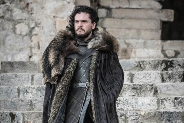 Kit Harrington as Jon Snow, stood on the stone steps of a castle, wearing his winter furs and leather (Credit: HBO)